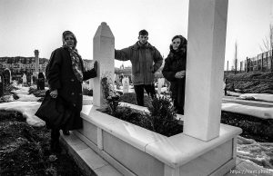 Nona Hogic, Amer Hogic, and Aziza Komaric at the grave of a family member.