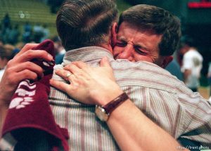 Craig Burr (right) weeps as he embraces his father after the North Sevier boys basketball team won the state championship. Burr has a son, Ryan, on the team and coached most of the boys when they were in 7th and 8th grade.  Burr can be found at the teams' games, camcorder in hand. 