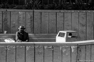 Old man on bench and graffiti reading 