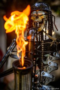 (Trent Nelson | The Salt Lake Tribune) A skeletal saxophone-playing sculpture by Fred Conlon gets flaming hot at the Utah Arts Festival in Salt Lake City, Thursday June 21, 2018.