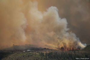 (Trent Nelson | The Salt Lake Tribune)The Dollar Ridge Fire threatens a structure, as seen from Fruitland in Duchesne County, Tuesday July 3, 2018.