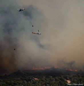(Trent Nelson | The Salt Lake Tribune)Helicopters make drops on the Dollar Ridge Fire near Fruitland in Duchesne County, Tuesday July 3, 2018.
