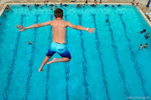 (Trent Nelson | The Salt Lake Tribune)  
A young swimmer leaps from the 10 meter platform at Kearns Oquirrh Park Fitness Center, Tuesday July 10, 2018.