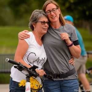 (Trent Nelson | The Salt Lake Tribune) Cyclists gather and ride around Salt Lake City's Liberty Park, Saturday July 21, 2018, in remembrance of Cameron Hooyer, a rider who was killed by a FrontRunner train during a 999 Ride on Thursday. Hooyer's mother Carla, left, is comforted.
