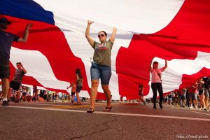 (Trent Nelson | The Salt Lake Tribune)   The Days of '47 Parade in Salt Lake City, Tuesday July 24, 2018. Volunteers carry a large flag.