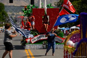 (Trent Nelson | The Salt Lake Tribune)   The Days of '47 Parade in Salt Lake City, Tuesday July 24, 2018. Two BYU fans rush out to wave their flags in front of the University of Utah's float.