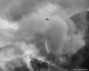 (Trent Nelson | The Salt Lake Tribune)  
A helicopter makes drops on a wildfire east of Tooele. Friday July 27, 2018.