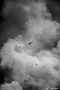 (Trent Nelson | The Salt Lake Tribune)   A helicopter makes drops on a wildfire east of Tooele. Friday July 27, 2018.