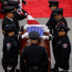 (Trent Nelson | The Salt Lake Tribune)   West Valley City police officers perform a flag presentation for family members at funeral services for Jill Robinson, a West Valley City code-enforcement officer killed on the job last week. The service took place at the Maverik Center in West Valley City on Friday Aug. 17, 2018.
