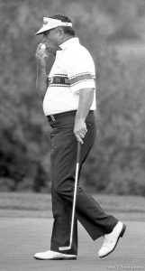 Lee Trevino kisses his ball after sinking a putt at PGA golf tournament.