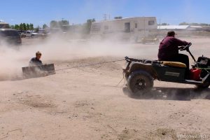 Trent Nelson  |  The Salt Lake Tribune kids riding grate behind mover, Monday May 1, 2017.