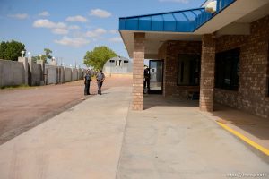 Trent Nelson  |  The Salt Lake Tribune Mohave County Sheriff deputies on the grounds of what had been the FLDS food storehouse in Colorado City, AZ, as locksmith Kelvin Holdaway changes the locks during an eviction, Monday May 8, 2017.