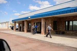Trent Nelson  |  The Salt Lake Tribune Mohave County Sheriff deputies on the grounds of what had been the FLDS food storehouse in Colorado City, AZ, as locksmith Kelvin Holdaway changes the locks during an eviction, Monday May 8, 2017.