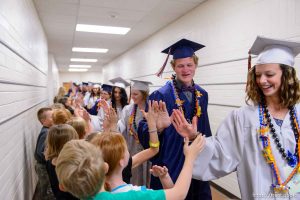 Trent Nelson  |  The Salt Lake Tribune Water Canyon High School graduates walk a procession of high-fives through Water Canyon Elementary prior to the high school's graduation ceremony in Hildale, Monday May 22, 2017. Two years ago the school had one graduate, this year twenty-five.