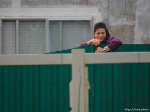 Trent Nelson  |  The Salt Lake Tribune An FLDS girl watches as the locks are changed on an empty home in Colorado City, AZ, Tuesday May 9, 2017.