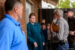 Trent Nelson  |  The Salt Lake Tribune FLDS member Julia Johnson confronts Mohave County Constable Mike Hoggard, disputing the UEP Trust's ability to evict her from a property in Colorado City, AZ, Tuesday May 9, 2017. Locksmith Kelvin Holdaway in blue.