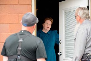 Trent Nelson  |  The Salt Lake Tribune FLDS member Julia Johnson confronts Mohave County Constable Mike Hoggard, disputing the UEP Trust's ability to evict her from a property in Colorado City, AZ, Tuesday May 9, 2017. Ted Barlow at left.