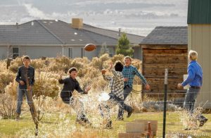 (Trent Nelson | The Salt Lake Tribune) A group of boys in long-sleeved shirts play backyard football at a Cedar City home where members of the polygamous Fundamentalist Church of Jesus Christ of Latter-Day Saints are purported to live, Wednesday November 8, 2017.