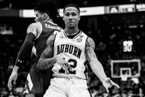 (Trent Nelson | The Salt Lake Tribune)   Auburn Tigers guard J'Von McCormick (12) plays air guitar to celebrate a basket as Auburn faces New Mexico State in the 2019 NCAA Tournament in Salt Lake City on Thursday March 21, 2019.