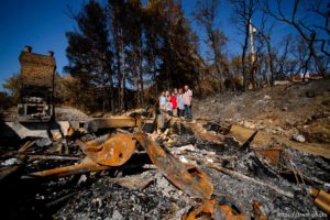 (Trent Nelson  |  The Salt Lake Tribune)  
Family members pose with Daniel and Cherilyn Fisher in the remains of their Bountiful home on Friday Sept. 6, 2019. From left, Diana Hare, Cherilyn Fisher, Evan Hare, Daniel Fisher, Desmond Hare, Sheila Hare, and Ryan Hare.