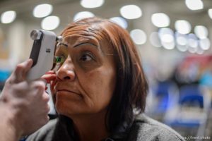 (Trent Nelson  |  The Salt Lake Tribune) Gloria Red Bear has an eye exam, leading to a free pair of glasses at Project Homeless Connect, where community volunteers to provide services for individuals and families experiencing homelessness, at the Salt Palace Convention Center in Salt Lake City on Friday Oct. 25, 2019.