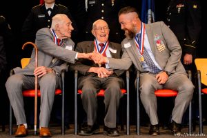 (Trent Nelson  |  The Salt Lake Tribune)
Veterans Leland Hortman (WW2), Earl Jacklin (WW2), and Glenn Johnson (Afghanistan, Iraq) shake hands while being recognized at the Veterans Day Commemoration at the University of Utah in Salt Lake City on Monday Nov. 11, 2019.