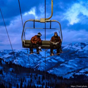 (Trent Nelson  |  The Salt Lake Tribune) Snowboarders on a lift as night sets in at Brighton on Monday, Feb. 24, 2020.