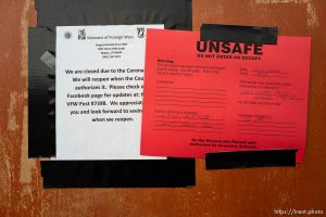 (Trent Nelson  |  The Salt Lake Tribune) A closure notice due to COVID-19 is covered up by a warning notice after earthquake damage to the VFW Post in Magna, as seen on Tuesday, March 24, 2020.