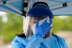 (Trent Nelson  |  The Salt Lake Tribune) Jessica Picaso sanitizes her face shield while working at a COVID-19 testing event sponsored by Comunidades Unidas at Mid-Valley Health Clinic in Midvale on Wednesday, May 20, 2020. The event was also sponsored by the Utah Partners for Health, Mid-Valley Health Clinic and the Utah Department of Health.