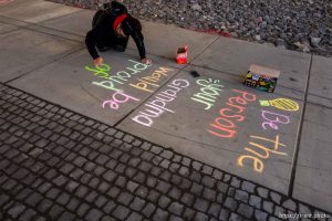 (Trent Nelson  |  The Salt Lake Tribune) Iola Idango writes hopeful messages on the sidewalk along North Temple in Salt Lake City on Saturday, May 23, 2020.