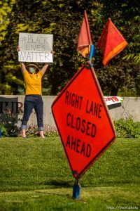 (Trent Nelson  |  The Salt Lake Tribune) Rev. Monica Dobbins holds a sign to passing traffic as a group of people protest police brutality in front of the First Unitarian Church in Salt Lake City on Friday, May 29, 2020.