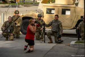 (Trent Nelson  |  The Salt Lake Tribune) A small group of Black Lives Matter activists led by Victoria Crosby kneel with National Guard and Salt Lake Police in front of the Public Safety Building in Salt Lake City on Tuesday, June 2, 2020.
