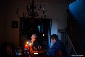 (Trent Nelson  |  The Salt Lake Tribune) Nick Kuzmack and his mother Frances Rowsell play chess by candlelight in their Salt Lake City home on Friday, Sept. 11, 2020. They have been without power since Tuesday's high winds.