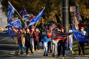 (Trent Nelson  |  The Salt Lake Tribune) A group of Trump supporters wave flags on the corner of 2100 S State Street in Salt Lake City on Tuesday, Nov. 3, 2020.