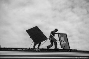 (Trent Nelson  |  The Salt Lake Tribune) A crew from Elan Solar installs solar panels on a Santaquin home on Friday, Nov. 6, 2020. roof: LJ Jenkins (green pants), RB Biel (jeans). ground: Eric Larkin (tan pants) and George Clement