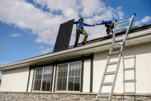 (Trent Nelson  |  The Salt Lake Tribune) LJ Jenkins and RB Biel, workers with Elan Solar, install solar panels on a Santaquin home on Friday, Nov. 6, 2020.