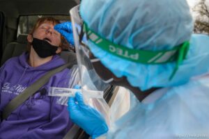 (Trent Nelson  |  The Salt Lake Tribune) Evandro Semedo tests Kellie Larsen at the Utah National Guard’s mobile testing site for COVID-19 in Salt Lake City on Tuesday, Nov. 10, 2020.