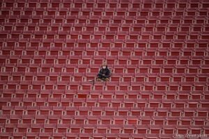 (Trent Nelson  |  The Salt Lake Tribune) A photographer surrounded by empty seats as the Utah Utes host the USC Trojans, NCAA football at Rice-Eccles Stadium in Salt Lake City on Saturday, Nov. 21, 2020.