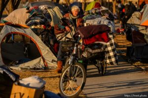(Trent Nelson  |  The Salt Lake Tribune) A woman packs up belongings as a cleanup crew from the health department approaches, in Salt Lake City on Wednesday, Dec. 9, 2020.