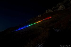 (Trent Nelson  |  The Salt Lake Tribune) A group of people, including many BYU students, shine Pride colors on the Y on the mountain above BYU in Provo on Thursday, March 4, 2021.