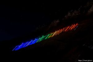 (Trent Nelson  |  The Salt Lake Tribune) A group of people, including many BYU students, shine Pride colors on the Y on the mountain above BYU in Provo on Thursday, March 4, 2021.
