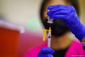 (Trent Nelson  |  The Salt Lake Tribune) Donna Burton preps a shot as teachers and staff of the Canyons School District received their second shots of the Moderna vaccine at Mount Jordan Middle School in Sandy on Thursday, March 11, 2021.