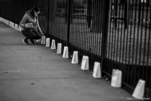 (Trent Nelson  |  The Salt Lake Tribune) Jen Voros checks on the 500 luminarias put out by students and teachers at the McGillis School in Salt Lake City, on Wednesday, March 17, 2021. The luminarias each have a message of gratitude and hope or a reflection on the past year's pandemic