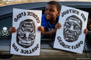 (Trent Nelson  |  The Salt Lake Tribune) Jamari and Jahavion Butoyi hold signs as people march in Salt Lake City on Tuesday, April 20, 2021 to mark the conviction of Derek Chauvin for the murder of George Floyd.