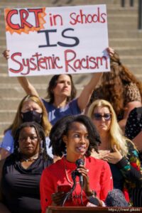 (Trent Nelson  |  The Salt Lake Tribune) As Michelle Love-Day speaks, Sophia Anderson (rear) holds up a sign with the opposite opinion, during a news conference by the Utah Educational Equity Coalition at the State Capitol in Salt Lake City on Wednesday, May 19, 2021.