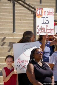 (Trent Nelson  |  The Salt Lake Tribune) People stand behind Darlene McDonald holding opposing signs during a news conference by the Utah Educational Equity Coalition at the State Capitol in Salt Lake City on Wednesday, May 19, 2021.