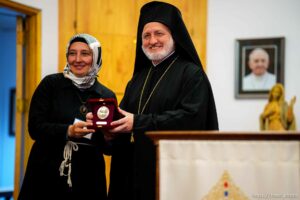 (Trent Nelson  |  The Salt Lake Tribune) His Eminence Archbishop Elpidophoros of America  presents a medallion to Zeynep Karipardue during a visit to the Cathedral of the Madeleine in Salt Lake City on Tuesday, July 20, 2021.