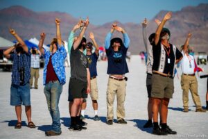 (Trent Nelson  |  The Salt Lake Tribune) People point up at the sky to falling debris, helping to ensure that it doesn't fall on unsuspecting spectators. Utah Rocket Club hosted Large Dangerous Rocket Ships, one of the country's premier rocketry events, at the Bonneville Salt Flats on Saturday, July 31, 2021.