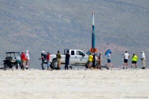 (Trent Nelson  |  The Salt Lake Tribune) Bryce Chanes and a group of helpers set up his rocket Porthos for launch. Utah Rocket Club hosted Large Dangerous Rocket Ships, one of the country's premier rocketry events, at the Bonneville Salt Flats on Saturday, July 31, 2021. Porthos reached an altitude of 5,558 feet— more than a mile.