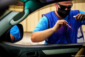 (Trent Nelson  |  The Salt Lake Tribune) Bryce Combe administers a dose of the Pfizer COVID-19 vaccine at a drive-thru event organized by the Utah County Health Department in Spanish Fork on Friday, Sept. 10, 2021.